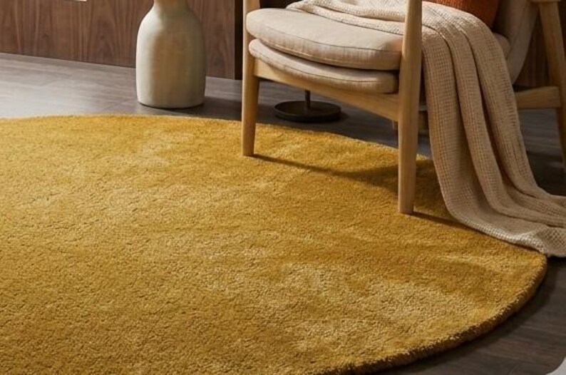 Close up texture of mustard yellow hand tufted wool rug showing dense soft cut pile fibers, premium handmade wool carpet