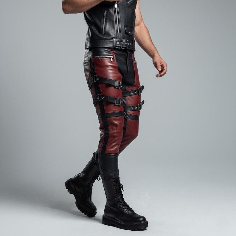 May include: Black and dark red leather pants featuring multiple horizontal straps with silver-toned metal buckles across the thighs and knees, paired with a matching black leather vest and black lace-up combat boots with thick soles.