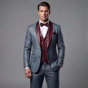 May include: A formal gray suit with a burgundy lapel, vest, and bow tie. The suit includes a matching jacket, vest, and trousers. The suit is worn with a white dress shirt and a pocket square. The suit is a classic formal wear ensemble.