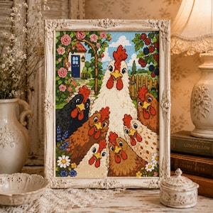 May include: A framed cross-stitch embroidery depicting a group of six chickens of various colors, including white, black, and brown, gathered in a garden setting with a blue door, pink roses, and green foliage under a bright blue sky.