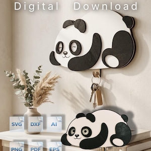 Könnte beinhalten: Eine digitale Download-Datei mit einem Design für einen Wandhaken in Panda-Form. Die Grafik zeigt einen weißen und schwarzen Panda mit geschlossenen Augen und einem kleinen Lächeln. Die Dateiformate sind SVG, DXF, AI, PNG, PDF und EPS.