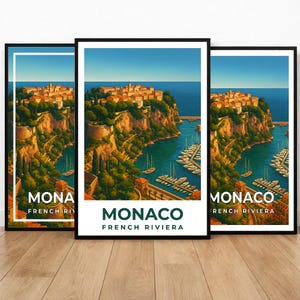May include: Three framed art prints showcasing a scenic view of Monaco on the French Riviera. The artwork depicts a coastal town with buildings atop a cliff, a harbor filled with boats, and the text "MONACO FRENCH RIVIERA".