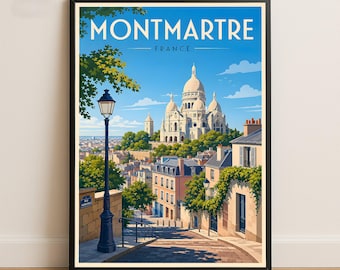 May include: A framed travel poster featuring the text MONTMARTRE FRANCE. The illustration depicts a street scene leading toward the Sacré-Cœur Basilica under a bright blue sky, with a black street lamp, green trees, and stone buildings.