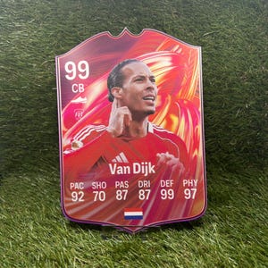 Könnte beinhalten: Eine rechteckige Sammel-Sportkarte mit einem Porträt von Virgil van Dijk in einem roten Trikot. Die Karte zeigt eine Gesamtbewertung von 99, die Position CB und Spielerstatistiken wie 92 PAC, 70 SHO, 87 PAS, 87 DRI, 99 DEF und 97 PHY sowie eine niederländische Flagge.