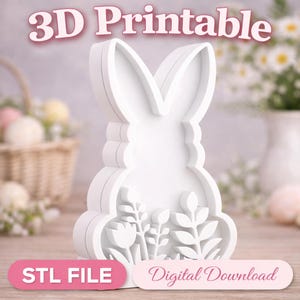 Peut inclure: Un emporte-pièce en forme de lapin blanc imprimable en 3D avec des détails floraux. L'image comprend le texte "3D Printable", "STL File" et "Digital Download". Le découpeur est conçu avec une silhouette de lapin et des éléments floraux décoratifs.
