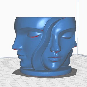 May include: A blue decorative planter featuring three stylized faces with closed eyes. The faces are sculpted in a continuous, flowing design, creating a unique and artistic aesthetic. The planter has a round base.