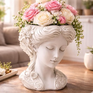 May include: A white bust planter, adorned with a woman's face, overflowing with pink and cream roses and foliage. The planter features floral detailing and the text "ELEGANT BUST PLANTER". The words "3D PRINTABLE" and "Digital Download" are also visible.
