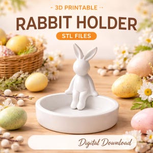 Könnte beinhalten: Ein weißer Keramik-Kaninchenhalter mit einer sitzenden Hasenfigur. Der Halter ist eine runde Schale. Das Bild enthält den Text "3D Printable", "Rabbit Holder", "STL Files" und "Digital Download". Ostereier und Blumen umgeben den Halter.