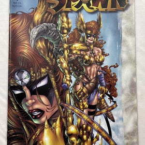 May include: Curse of the Spawn issue number 9 comic book featuring a detailed illustration of a character with long red hair wearing gold armor and a black mask. The cover includes the title text, the Image logo, and a price of $1.95 US.