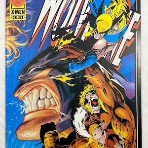 May include: A Marvel Comics X-Men Deluxe comic book from February 1990 featuring Wolverine and Sabretooth in a dynamic battle scene. The cover art displays Wolverine with extended claws above Sabretooth, who is snarling with bared teeth.