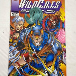 May include: A comic book cover for WildC.A.T.S. featuring several characters in action poses. The cover has a vibrant color scheme with the title in large, bold letters. The characters are depicted with dynamic energy, and the overall style is reminiscent of superhero comics.