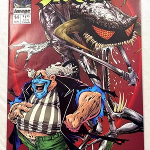 May include: Spawn comic book cover featuring a grotesque clown-like figure with blue skin and a striped shirt, alongside a monstrous creature with sharp teeth and claws. The title "Spawn" is prominently displayed.