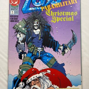 May include: Comic book cover for "The Lobo Paramilitary Christmas Special" featuring a muscular character with a knife, Santa Claus, and the text "Christmas Special." The cover has a purple background and the DC Comics logo.