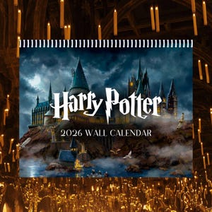 May include: A 2026 wall calendar featuring the Harry Potter logo and a detailed illustration of Hogwarts Castle. The image shows a dramatic sky, water, and flying birds, with a background of lit candles.