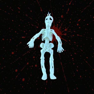 May include: A white plastic skeleton figurine with a loop for hanging. The skeleton is set against a black background with red splatter details, creating a spooky Halloween theme.