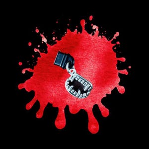 May include: A silver-colored charm in the shape of vampire teeth, attached to a black clasp. The charm is set against a vibrant red splatter on a black background. The charm has the word "Vampire" on it.
