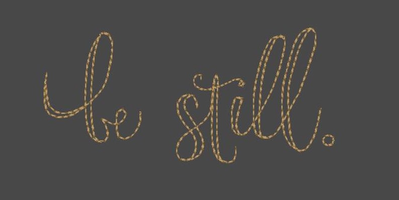 May include: Gold-colored script lettering on a dark gray background reads "be still." The words are formed from a textured, rope-like material, creating a tactile and elegant design. The period at the end of "still" is also gold.