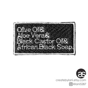May include: Black and white embroidered patch with the text "Olive Oil & Aloe Vera & Black Castor Oil & African Black Soap".