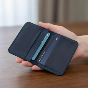 This Slim Leather Card Holder is handmade from genuine leather and designed for minimalist everyday carry. Compact and elegant, it works as a slim card wallet for men or custom credit card holder for essential cards. Engraving options make it a personalized card holder wallet and a thoughtful gift for men who value style and craftsmanship.