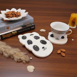 May include: A set of three ceramic mugs with a speckled, matte finish. Each mug features a different color: light blue, cream, and gray. The mugs have a simple, modern design and a comfortable handle.