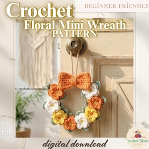 May include: A crochet floral mini wreath with an orange bow and colorful flowers. The wreath is suspended from a door. The image text reads "Crochet Floral Mini Wreath Pattern" and "digital download".