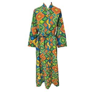 May include: A long-sleeved robe featuring a vibrant, multi-colored geometric pattern in shades of orange, green, blue, and yellow. The garment includes a matching fabric tie belt at the waist and a single circular button closure at the neckline.