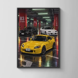 May include: A framed wall art print depicting three sports cars parked in a parking garage. A yellow car is in the foreground, with a black car and a white car behind it. The garage features red pillars labelled B3 and reflective wet floors.