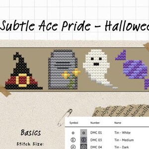 May include: A cross-stitch pattern titled Subtle Ace Pride - Halloween featuring four icons: a black witch hat with a red band, a grey tombstone with yellow flowers, a white ghost, and a purple candy. Includes a color key table and a safety pin.