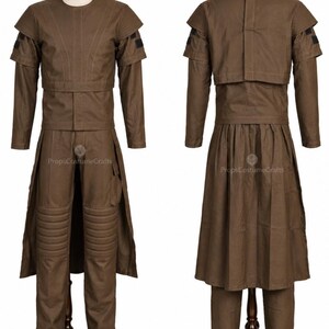 May include: A brown costume with a long-sleeved top, pants, and a long skirt-like piece. The top has a round neck and shoulder accents. The pants have knee padding. The costume is displayed on a mannequin.