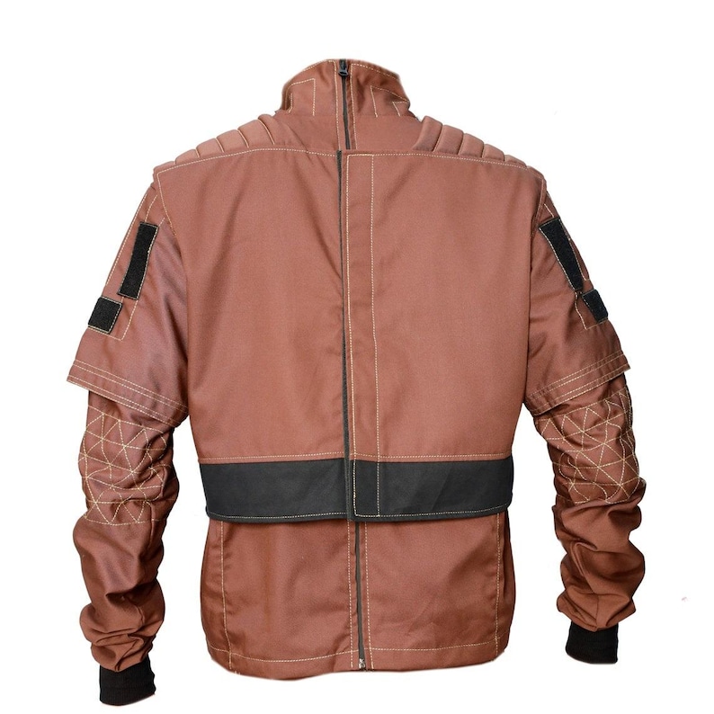 May include: A brown jacket with a high collar and a black band at the waist. The jacket has quilted detailing on the sleeves and black patches on the shoulders. The sleeves have black cuffs.