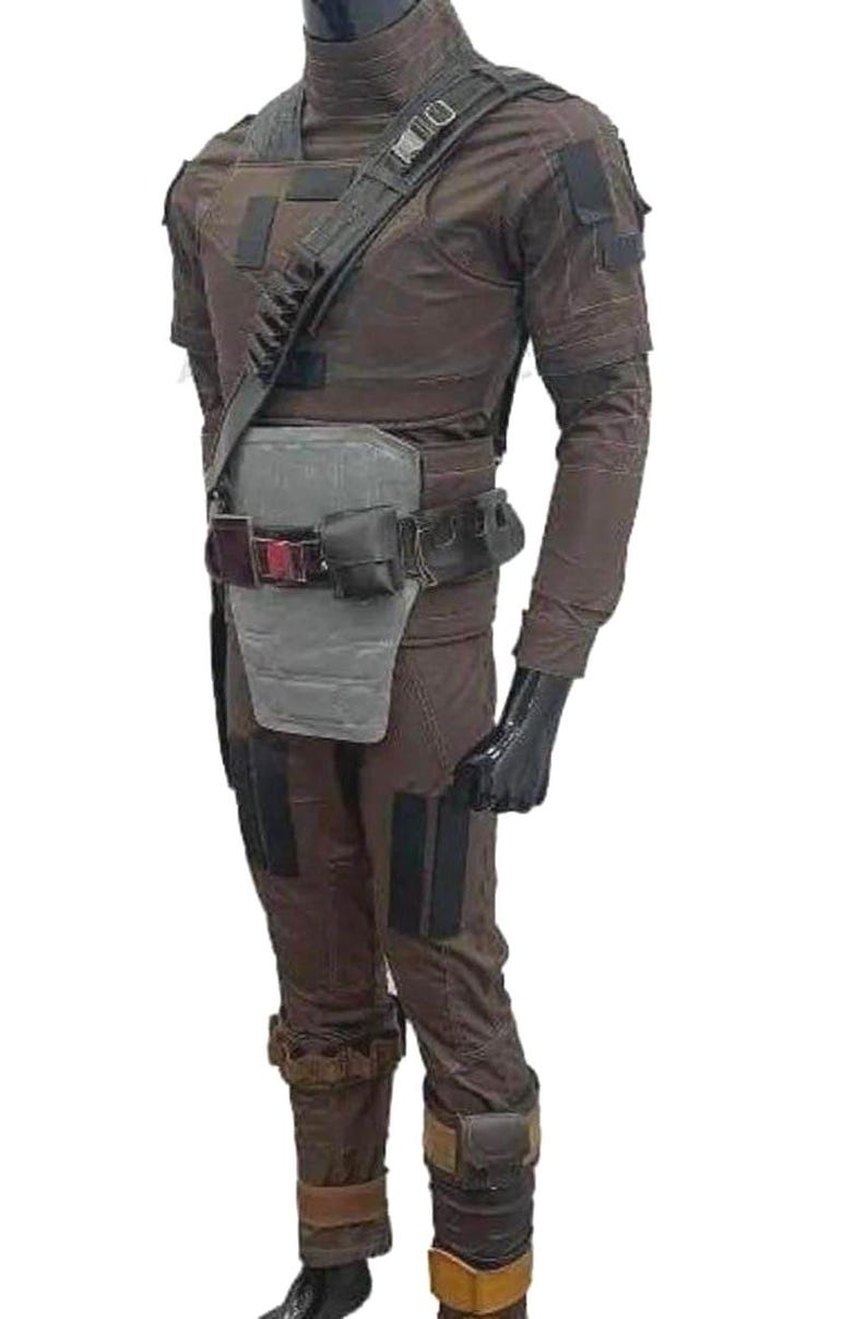May include: Brown tactical costume featuring a high collar, shoulder strap, and multiple pockets. The outfit includes a belt with pouches, a chest protector, and knee pads. Black gloves complete the look.