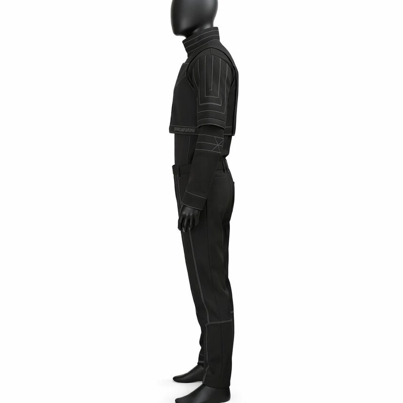 May include: A black outfit consisting of a cropped jacket, high-neck top, and pants. The jacket features geometric stitching on the shoulders and sleeves. The pants have a straight leg design with matching stitching. The outfit is displayed on a mannequin.
