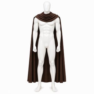 May include: A brown cape with a cowl neck, displayed on a white mannequin. The cape is long and flowing, reaching the mannequin's feet. The mannequin is standing against a white background.