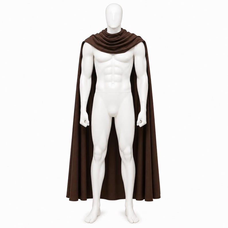 May include: A brown cape with a cowl neck, displayed on a white mannequin. The cape is long and flowing, reaching the mannequin's feet. The mannequin is standing against a white background.