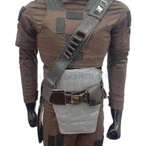 May include: Brown tactical vest and trousers set. The vest has a padded chest and shoulder straps with multiple pouches and a utility belt. The outfit is designed with a high collar and long sleeves. The overall design is a military-inspired style.