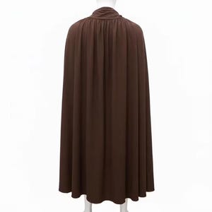 May include: A long, flowing brown cape with a high, gathered neckline. The cape is made of a soft, draping fabric and falls to the ankles. The back view shows vertical folds in the fabric.
