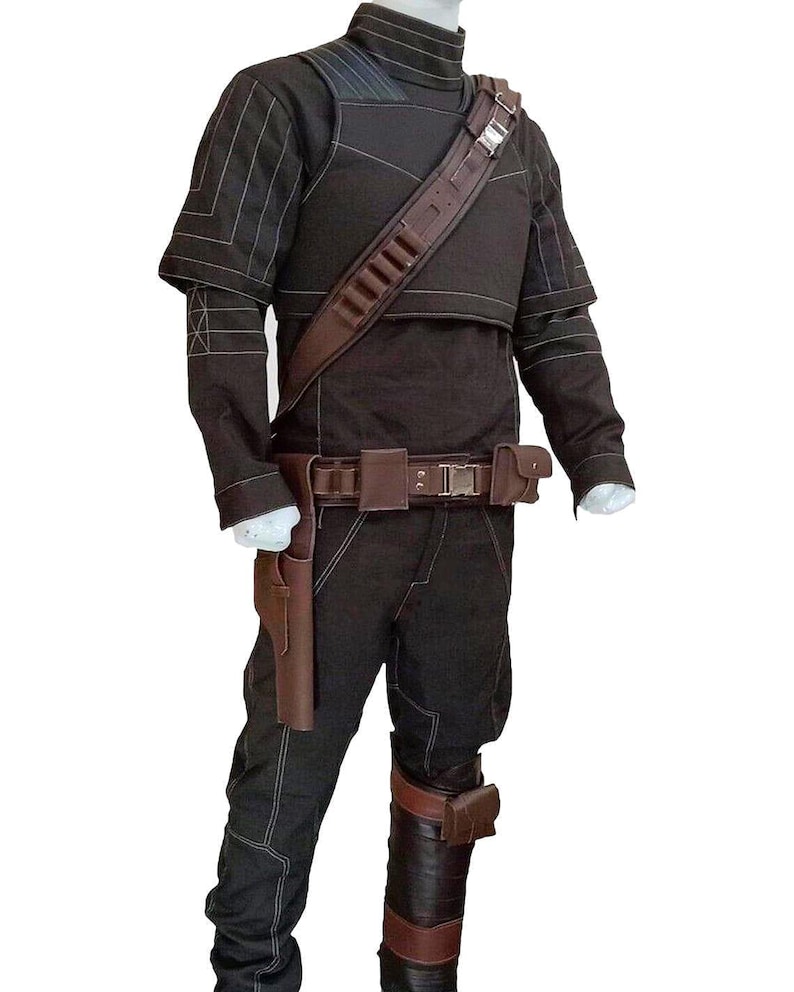 May include: A dark brown costume with white stitching. The outfit features a high-collared top, trousers, and a utility belt with a holster. A brown shoulder strap and leg armour complete the ensemble. Ideal for cosplay or themed events.