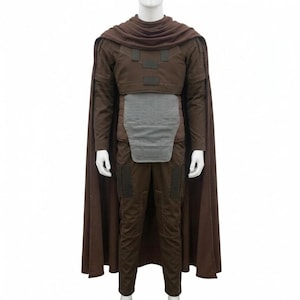 May include: A brown costume with a matching cape. The outfit includes a long-sleeved top, pants, and a chest piece. The cape drapes over the shoulders. The costume is displayed on a mannequin.