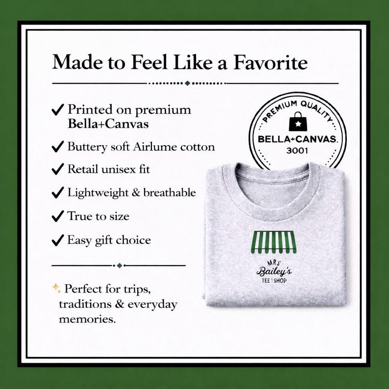 May include: A light grey t-shirt featuring the text "Mrs. Bailey's Tee Shop" and a green awning design. The shirt is made of soft Airlume cotton and is lightweight and breathable. The image also includes text about the shirt's features.