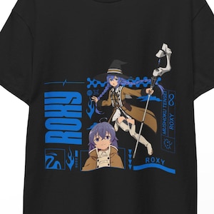 May include: Black t-shirt with a blue and brown anime character design, including the name "ROXY" in blue. The design features a character illustration with a staff and a smaller portrait. The t-shirt is displayed on a wooden hanger.
