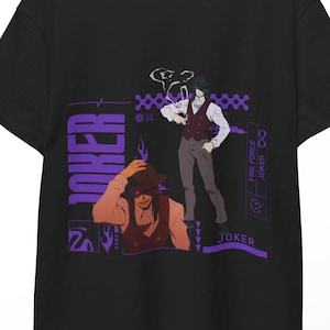May include: Black t-shirt with a purple graphic of two anime-style figures and the word "JOKER". The design includes additional text and symbols. The t-shirt is hanging on a wooden hanger against a white background.