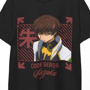 May include: Black t-shirt featuring an anime character illustration. The design includes a character portrait within a red and black rectangular frame, with Japanese text and the words "CODE GEASS Suzaku". The shirt is hanging on a wooden hanger.