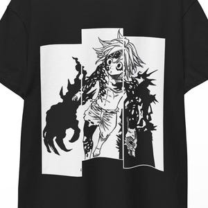 May include: Black t-shirt featuring a black and white graphic of an anime character with spiky hair and dark, shadowy details. The character is set against a white rectangular background. The shirt is hanging on a wooden hanger.
