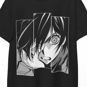 May include: Black t-shirt featuring a black and white manga-style graphic. The graphic is a close-up of a character's face, with detailed linework and expressive eyes. The design is divided into three vertical panels.
