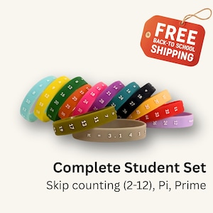 May include: A collection of colorful silicone wristbands featuring printed numbers for skip counting, prime numbers, and the mathematical constant pi. The bands are displayed in various hues including light blue, yellow, green, orange, pink, purple, teal, black, tan, red, and lavender, with white text.