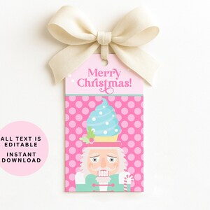 May include: A pink gift tag with a cream bow, featuring a cartoon nutcracker with a blue cupcake hat. The tag reads "Merry Christmas!" and has a pink polka dot background. A pink circle with text is on the left.