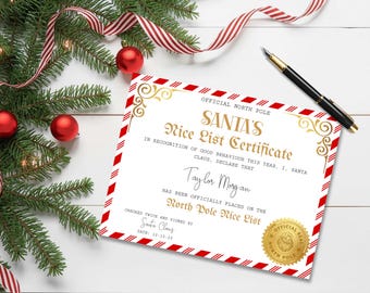 May include: A festive Christmas scene with a certificate, ornaments, and greenery. The certificate reads "SANTA'S Nice List Certificate" with a gold seal and the name "Taylor Morgan". A black pen and red and white striped ribbon are also present.