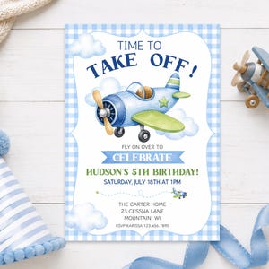 May include: A rectangular birthday invitation card with a blue gingham border, featuring a watercolor illustration of a blue airplane, white clouds, and the text: TIME TO TAKE OFF! FLY ON OVER TO CELEBRATE HUDSON'S 5TH BIRTHDAY! SATURDAY, JULY 18TH AT 1PM.
