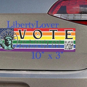May include: A rectangular bumper sticker measuring 10 inches by 3 inches featuring a rainbow background, the Statue of Liberty, and the text VOTE For Liberty and Justice for ALL. The design includes a QR code on the right side of the sticker.