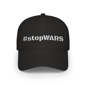 May include: Black baseball cap with the white text "#stopWARS" embroidered on the front. The cap has a curved brim and a structured fit. A simple, yet impactful design.